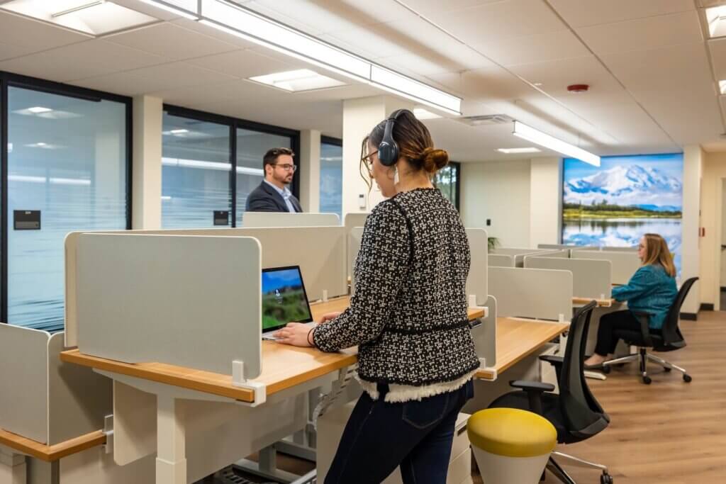 Two coworking members using our ergonomic adjustable sit-stand desks.